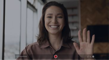 Woman waving & recording video