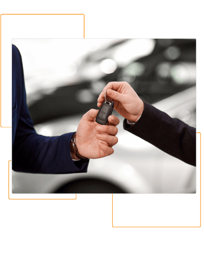 Automotive sale person handing someone the keys